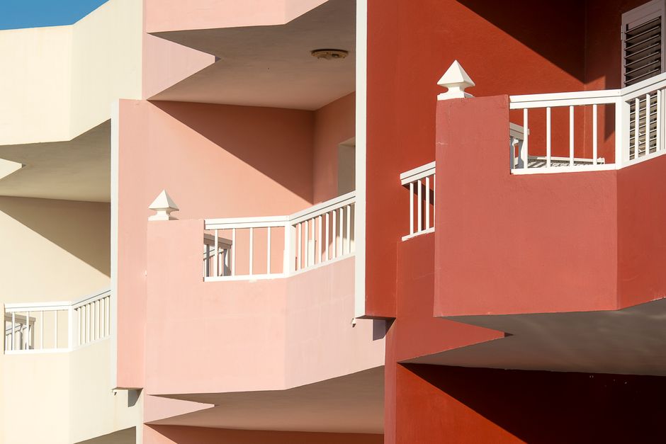 Vibrant view of colorful apartment balconies with geometric design.